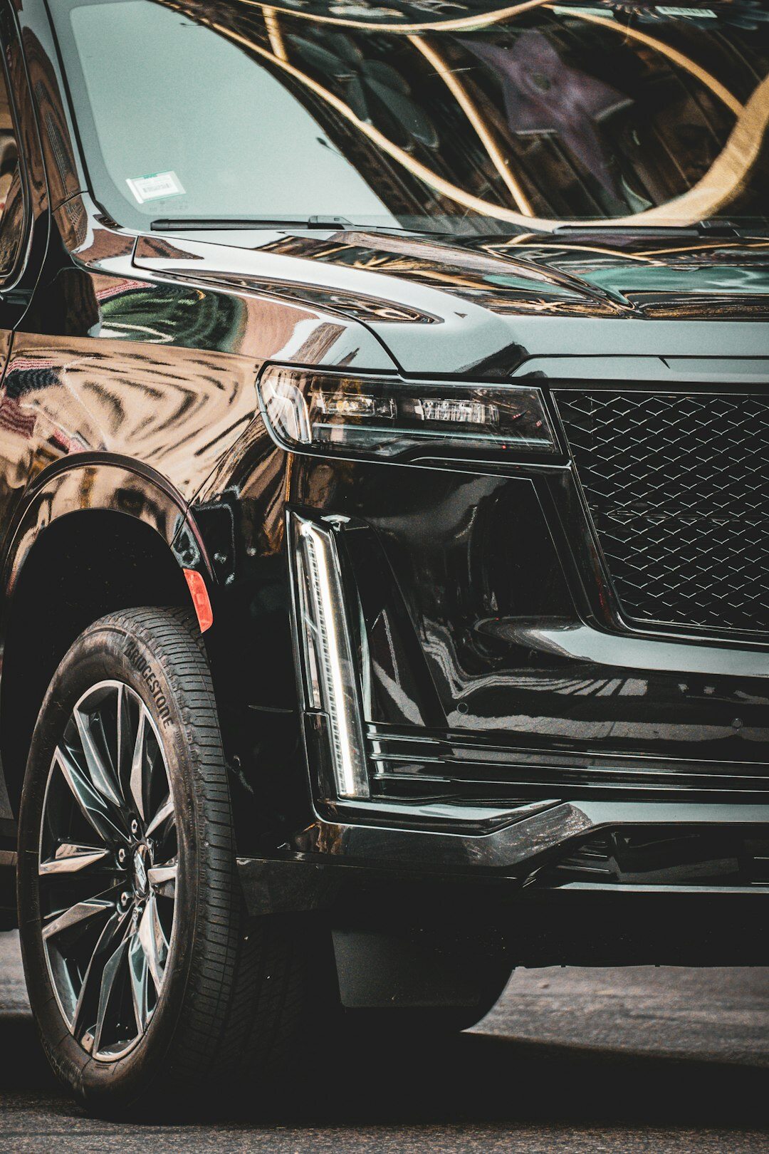 Black luxury SUV in a dark editorial studio setting