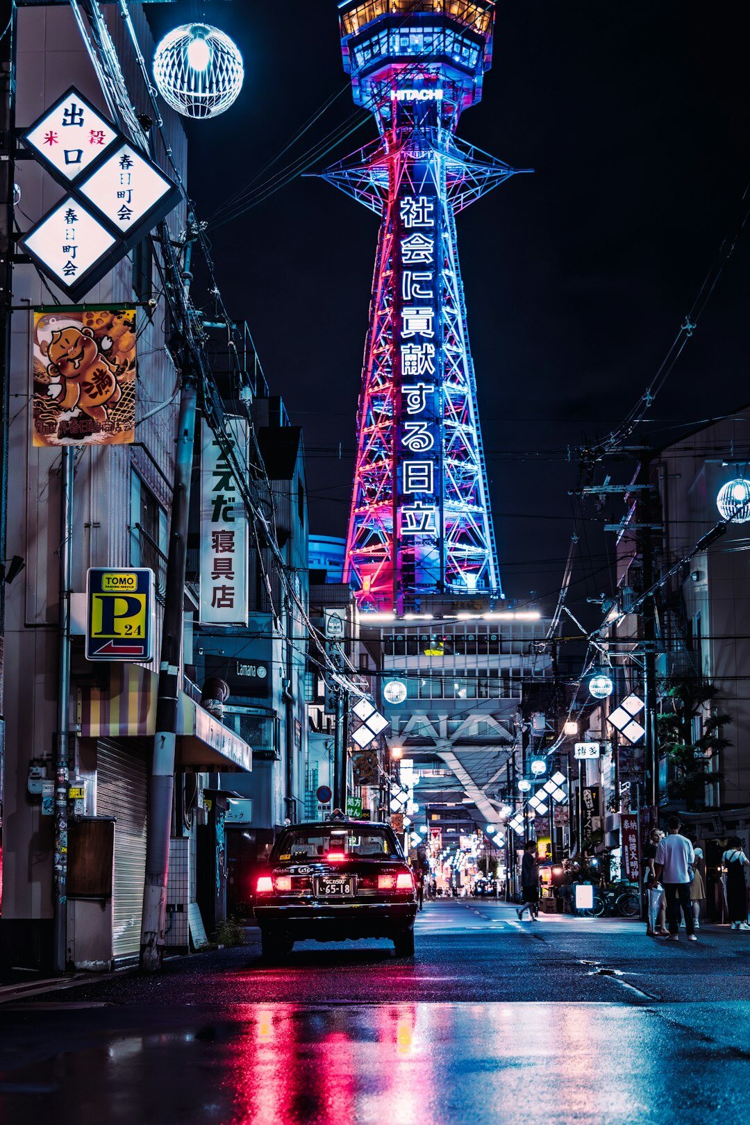 Japanese sedan on a neon lit city street at night