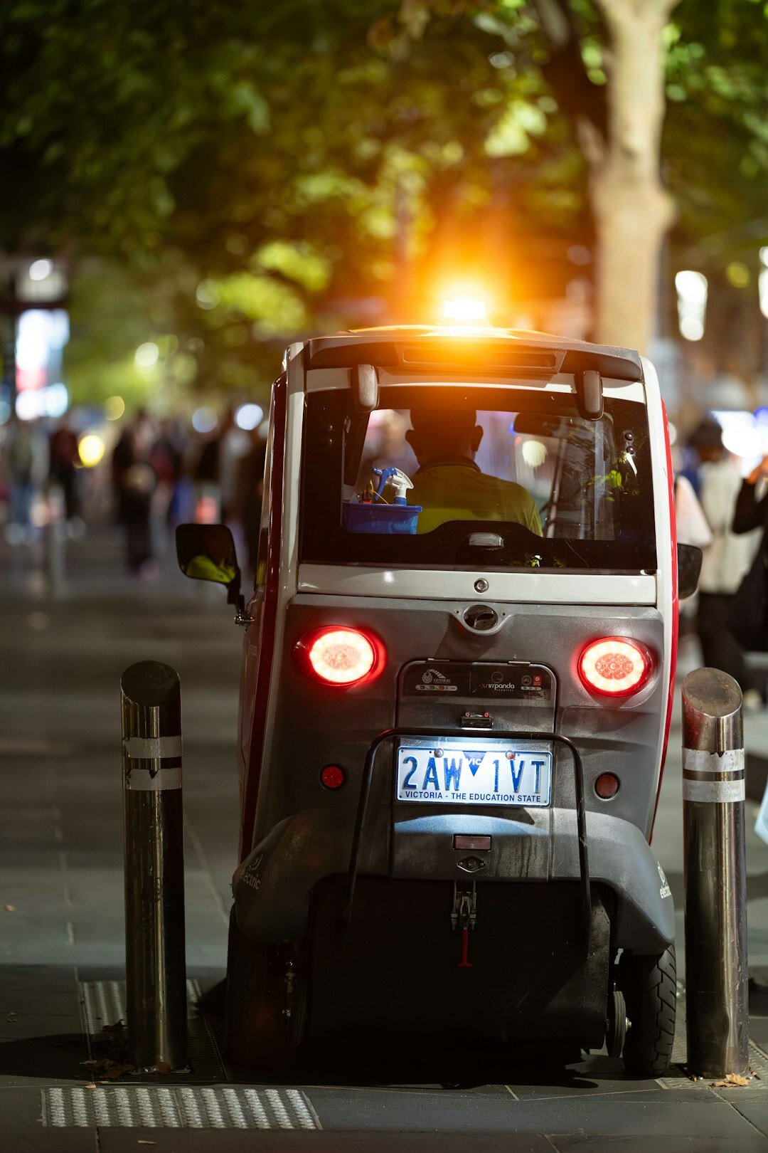 Small electric city car parked on an urban street