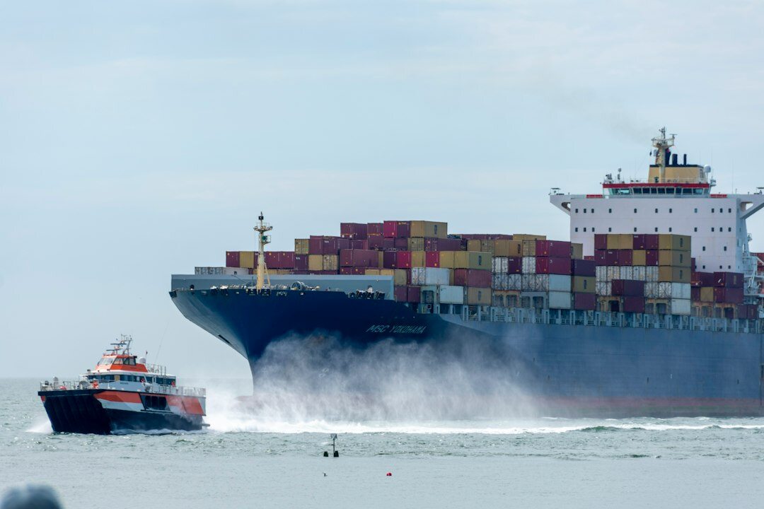 Cargo ship carrying vehicles arriving at a port harbor