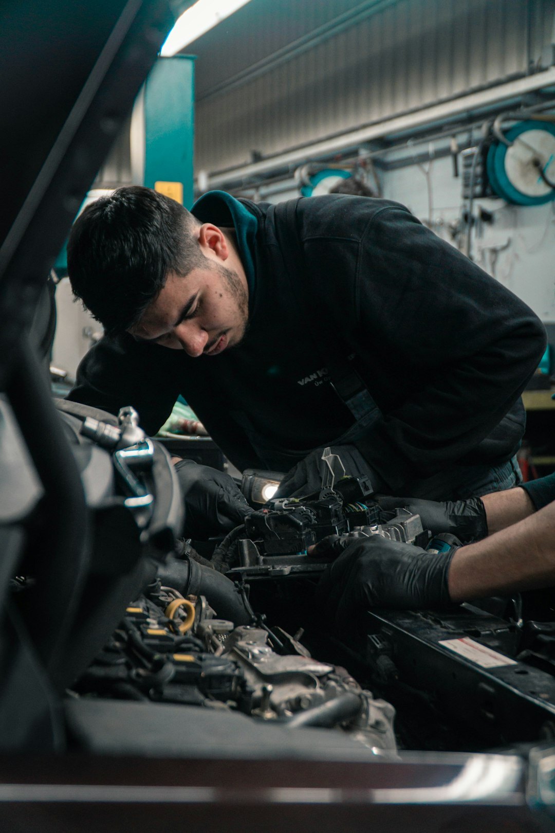 mechanic checking car oil