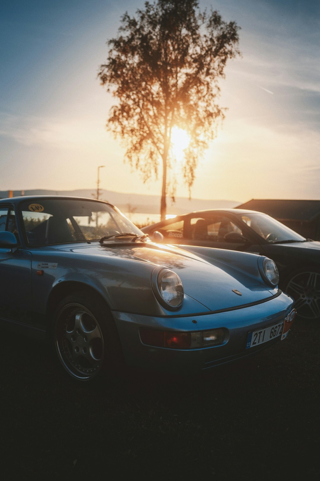 luxury car parked at sunset