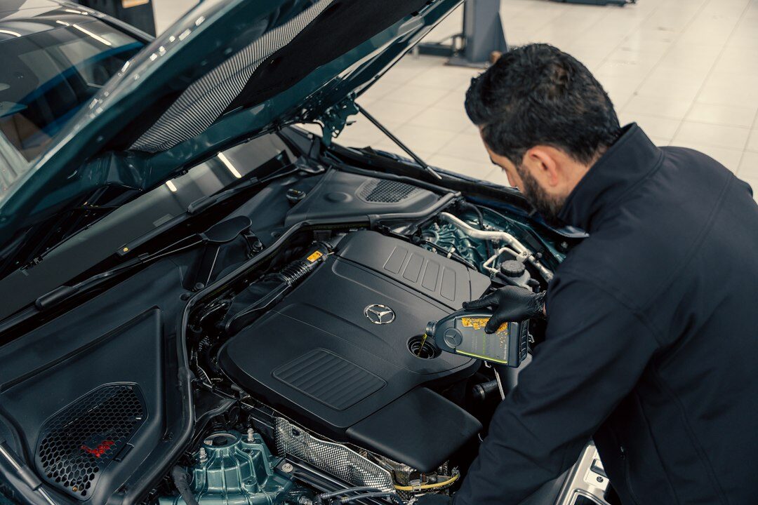 mechanic checking car oil